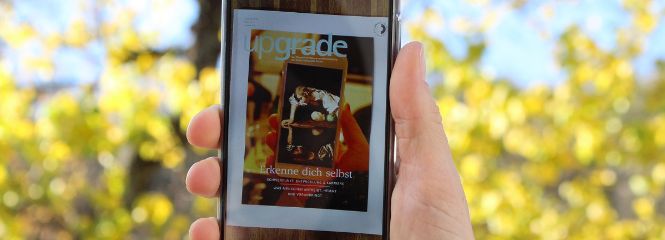 Upgrade Magazin auf Handy vor Weinreben