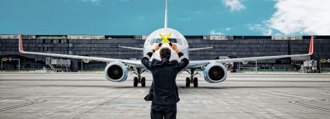 Alumnus stands in front of the airplane
