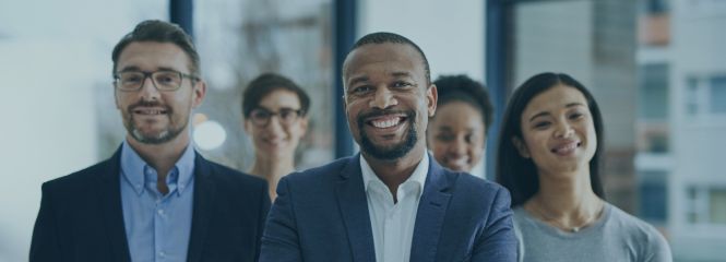 MBA image: A group of people from different backgrounds smiling at the camera.